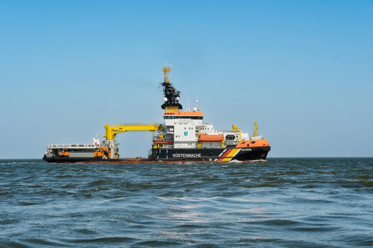 A coast guard vessel navigating the ocean, ensuring maritime safety and pollution control.